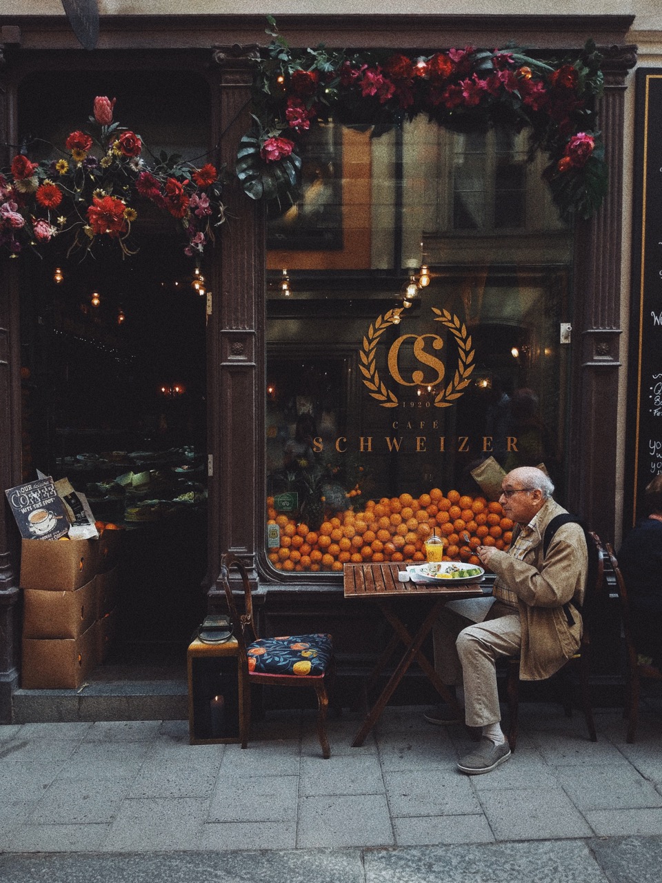 old man in front of cafe